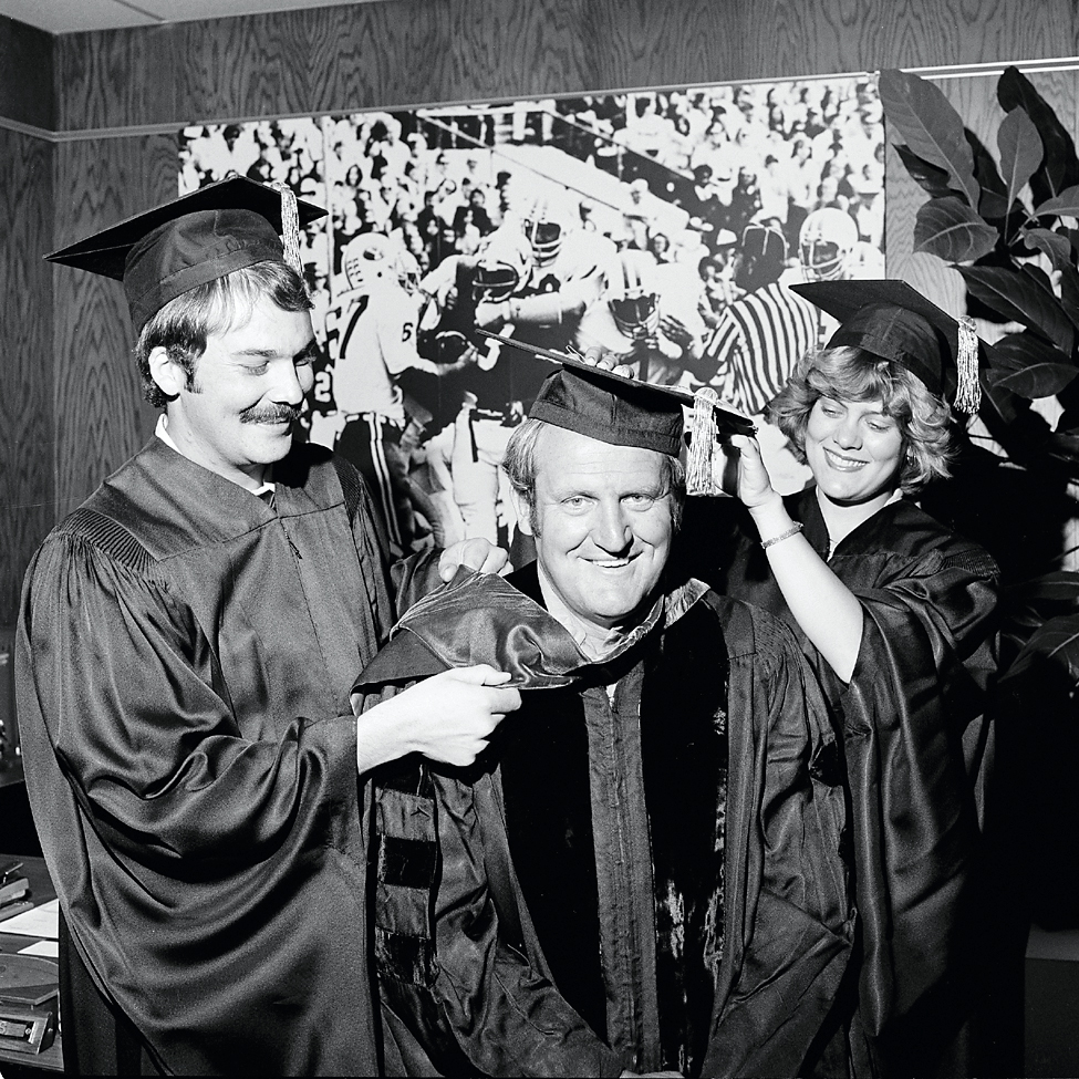 LaVell Edwards graduating with a graduation cap and robe on