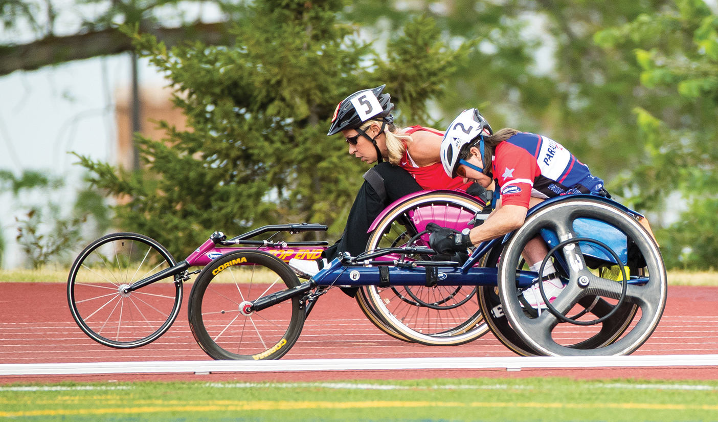 two people in wheelchairs on the track