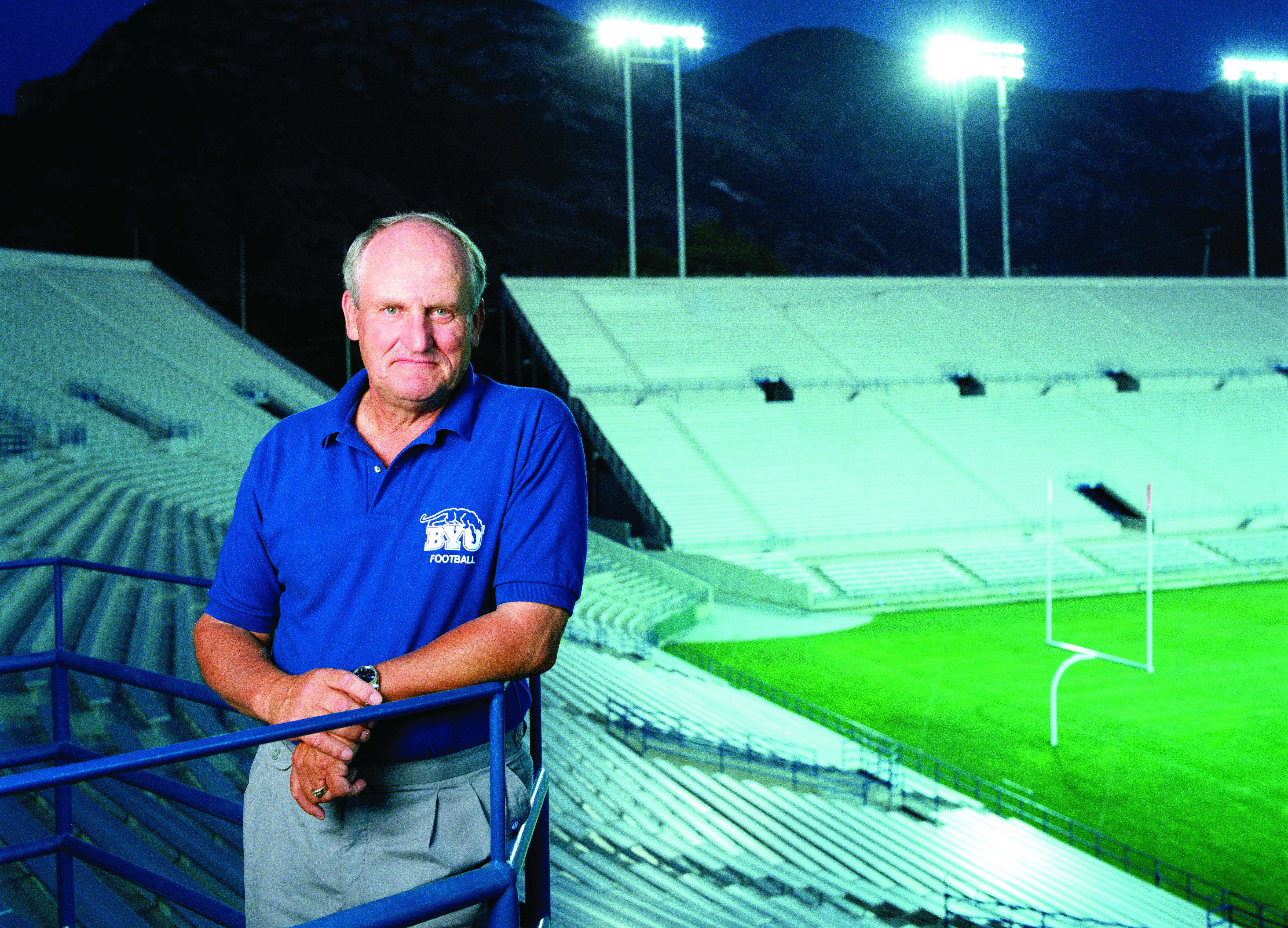 A throwback photo of legendary coach LaVell Edwards posing in front of the field that would bear his name.