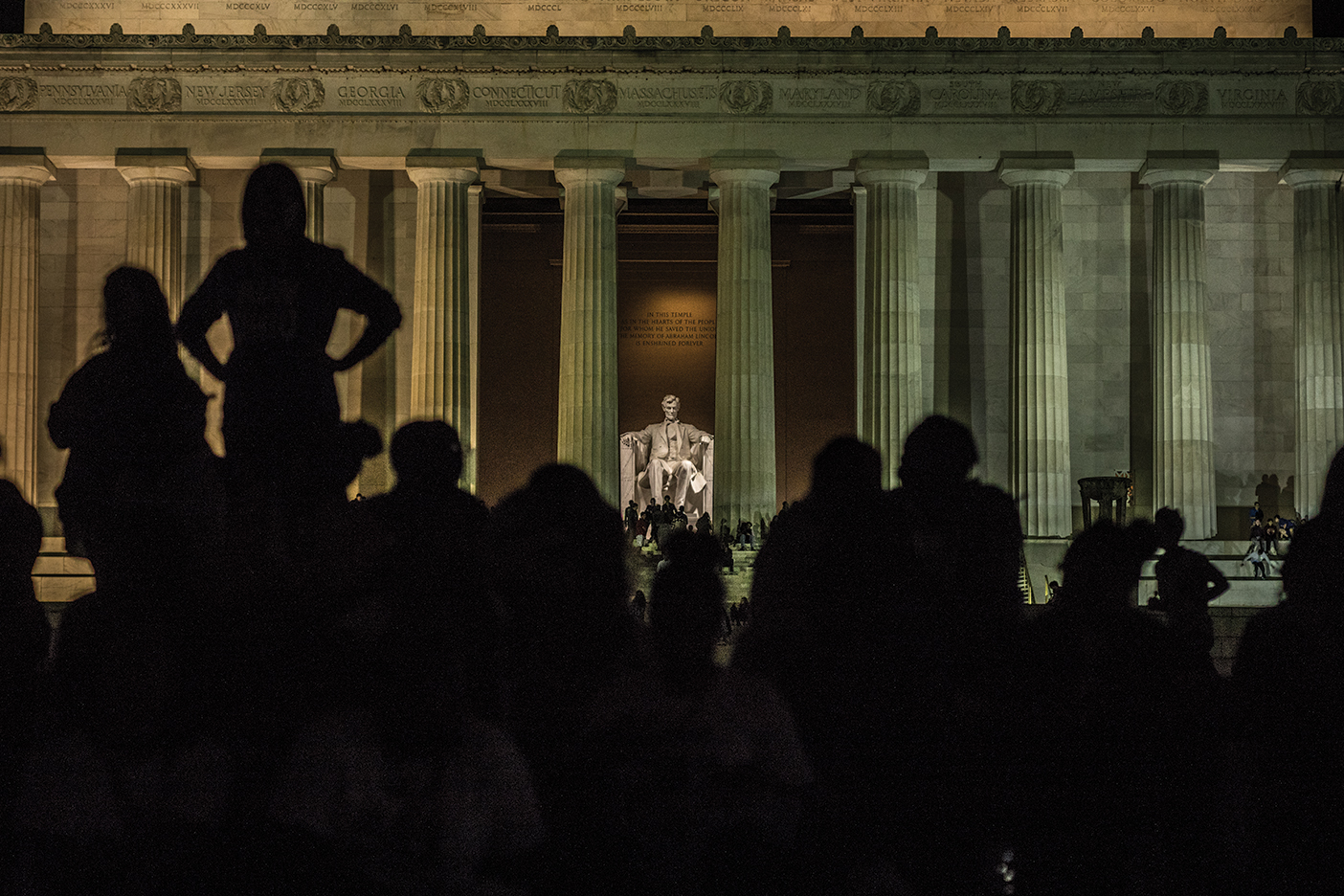 Visitors stand in front of the Lincoln Memorial.