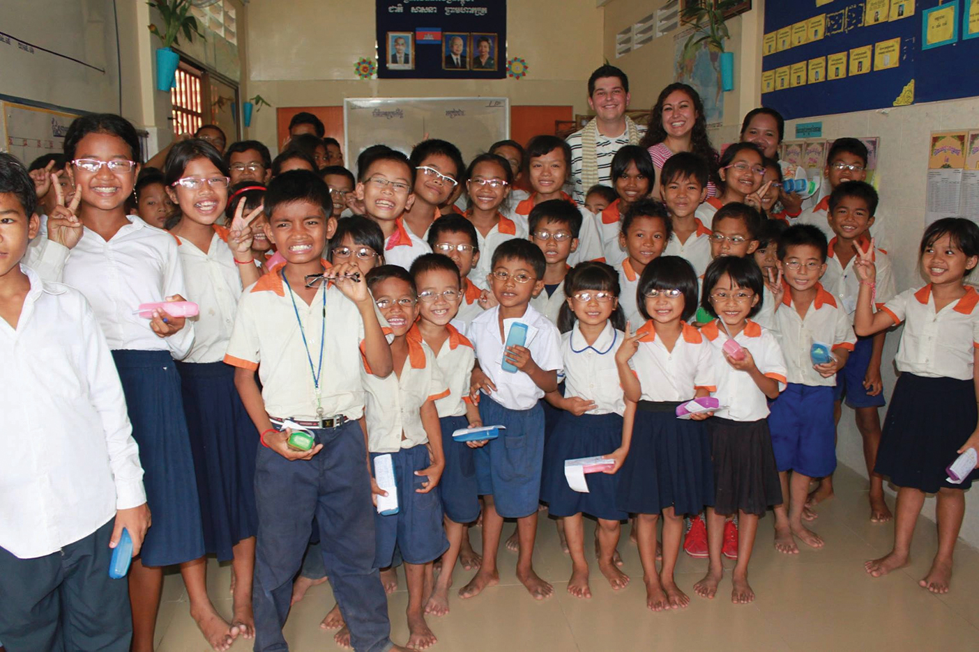 Trammel and Jen Cox surrounded by Asian children