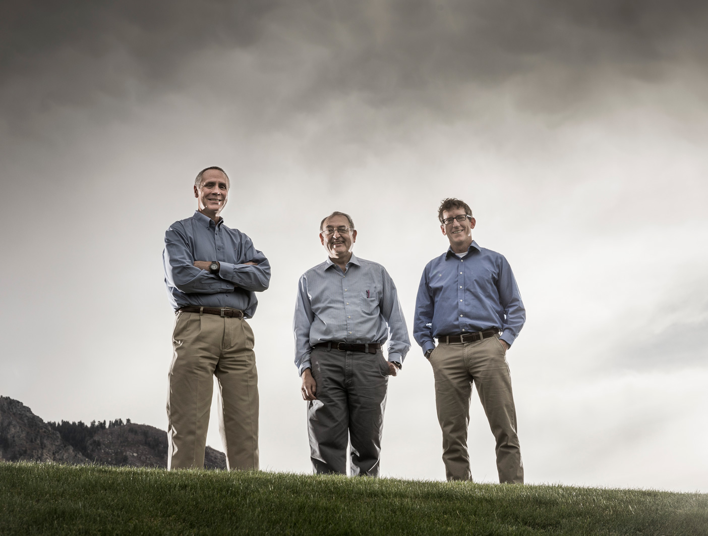 BYU professors Dennis Eggett, Lawrence Rees, and Mark Beecher pose under a gray sky.