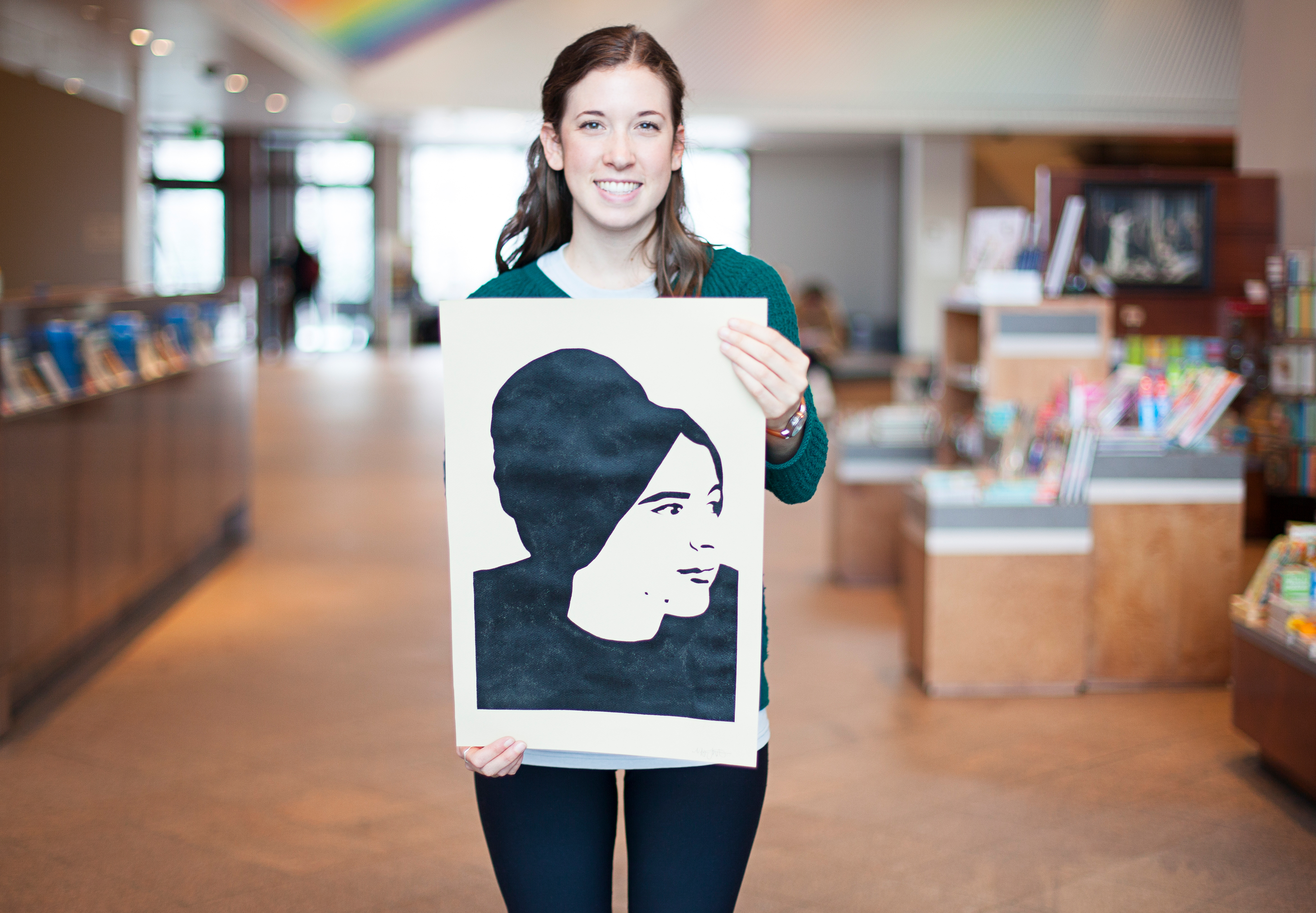 Megan Livingston holding her stencil of Eva Hesse