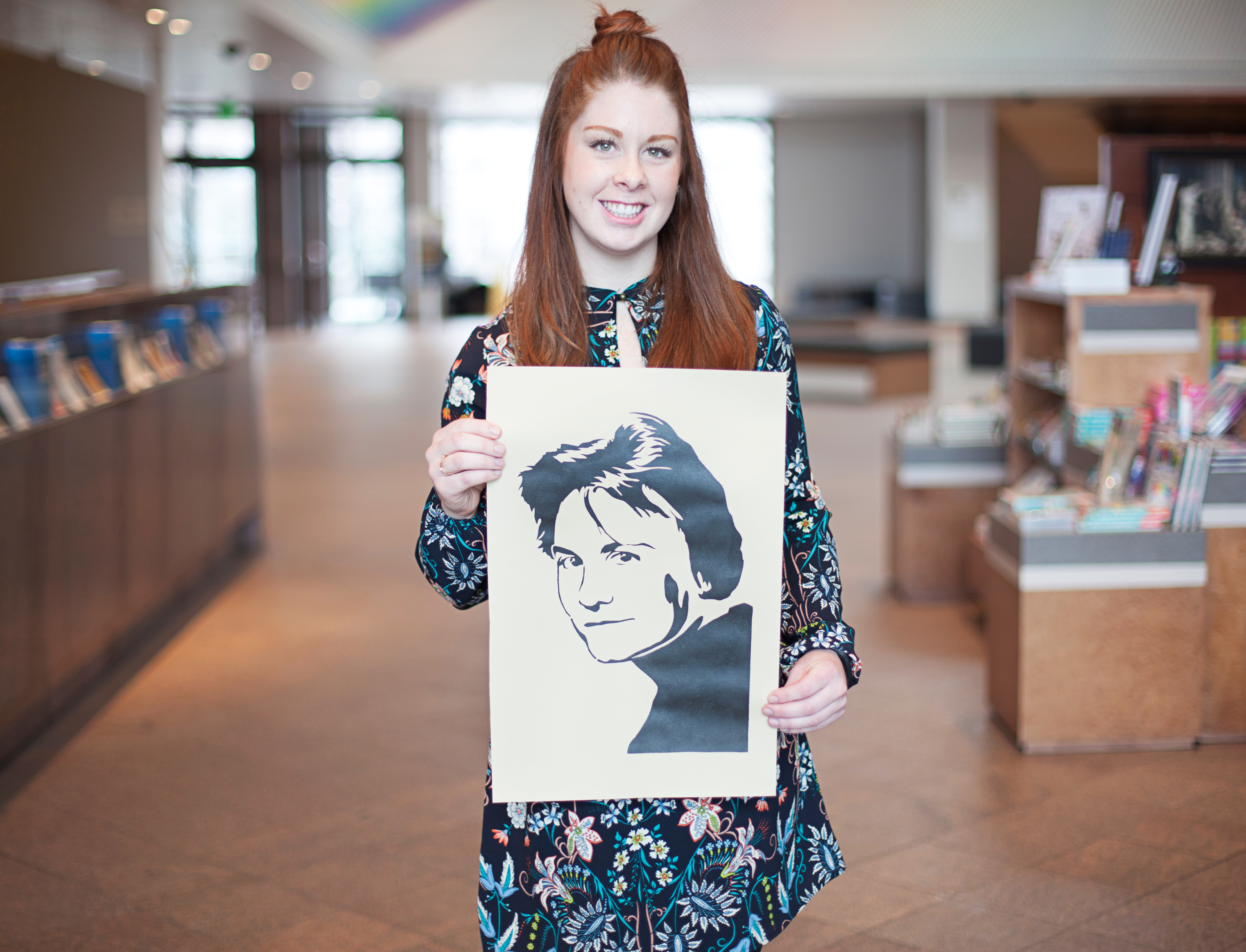 Sadie Dodson holding her stencil of Harper Lee