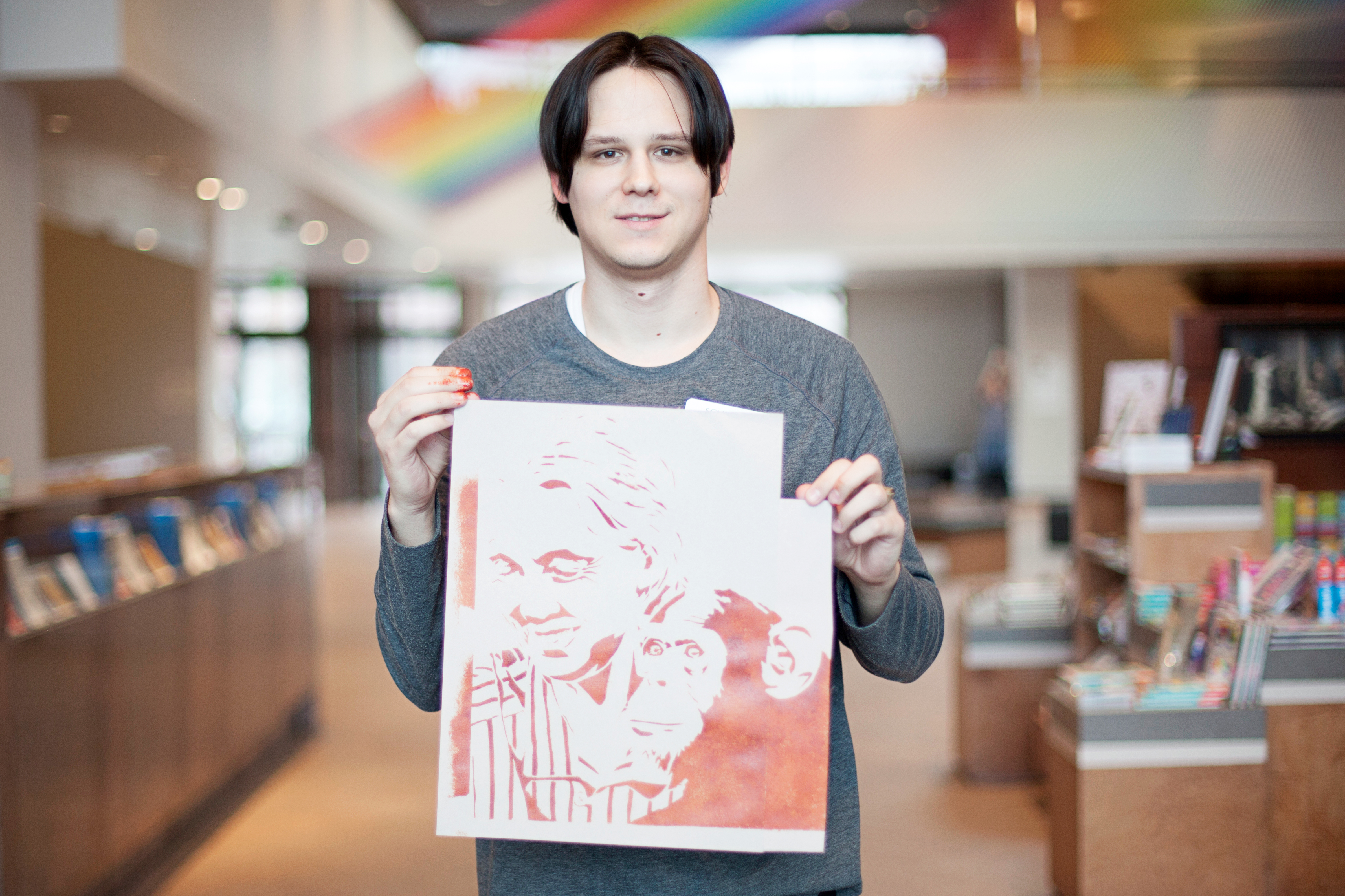 Schuyler Finley hold his stencil of Jane Goodall
