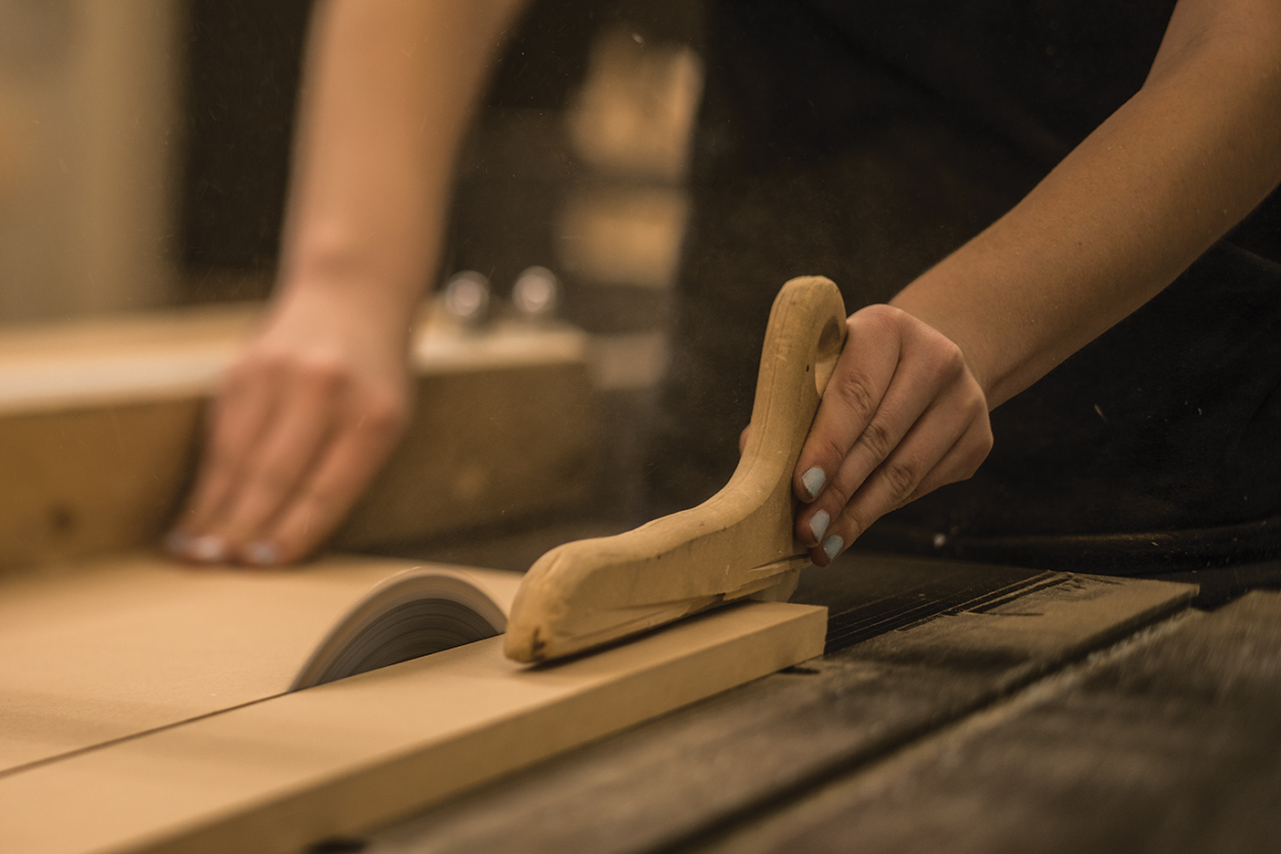 Image of someone cutting wood with a handsaw.