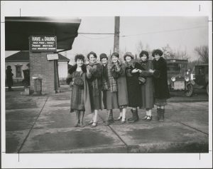 seven female BYU students dressed in long coats and hats