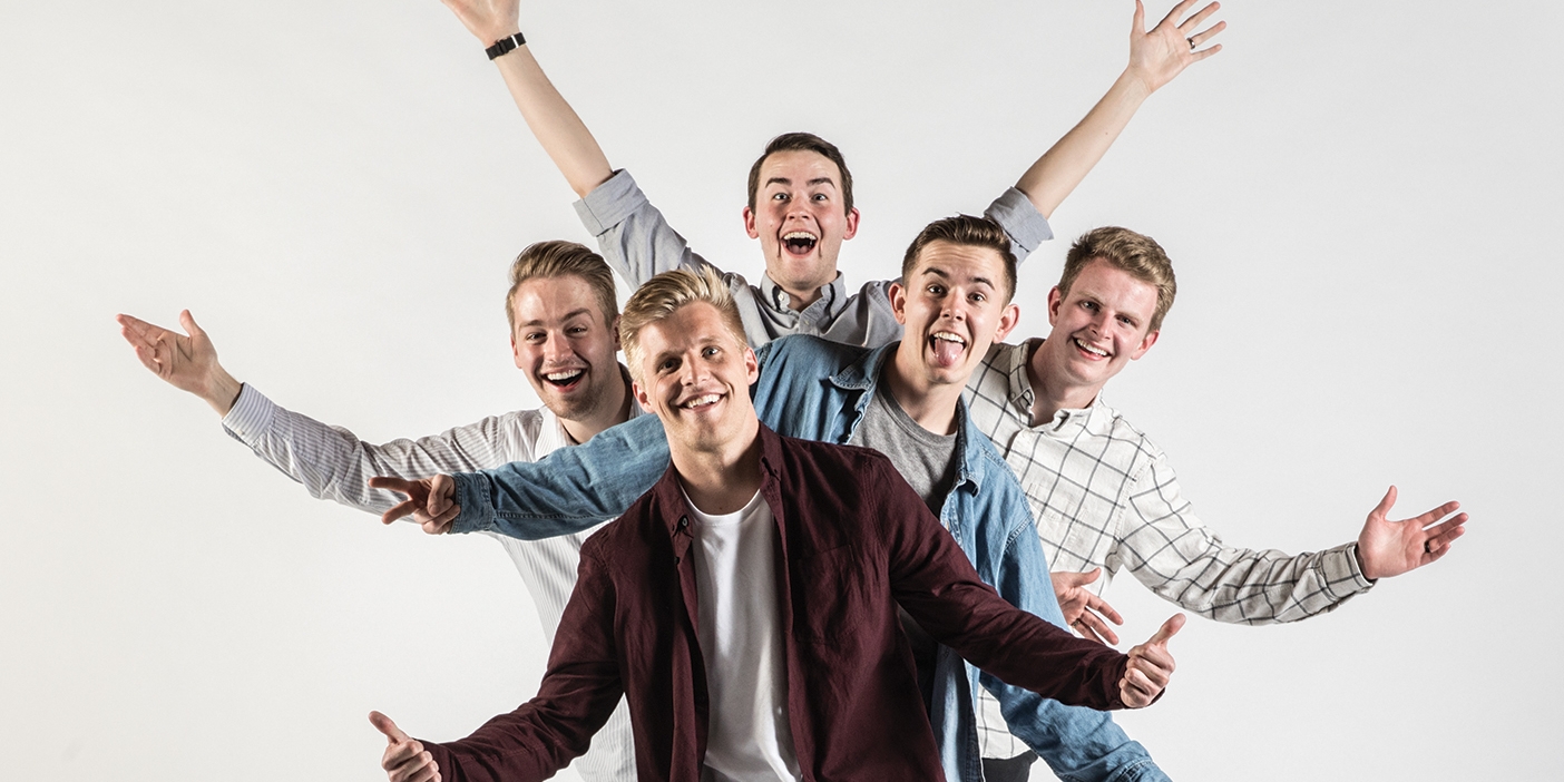 Members of the Hey Joe Show, Connor Peck, Sumner Mahaffey, Tylan Glines, Jacob Mingus, and Davis Blount, standing behind each other with their arms out.