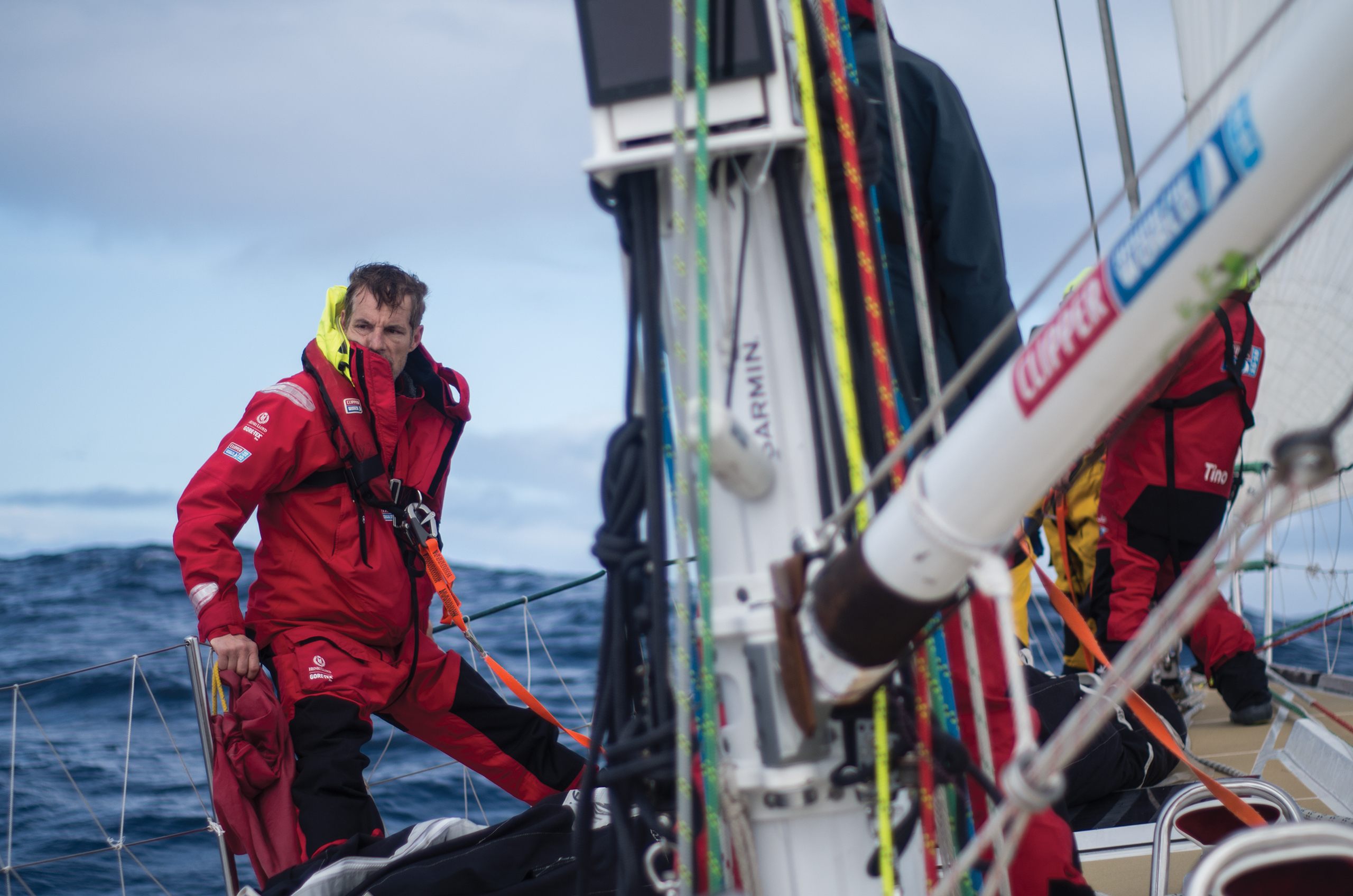 Martin Frey leans on the edge of his race yacht as he crosses the North Pacific ocean.