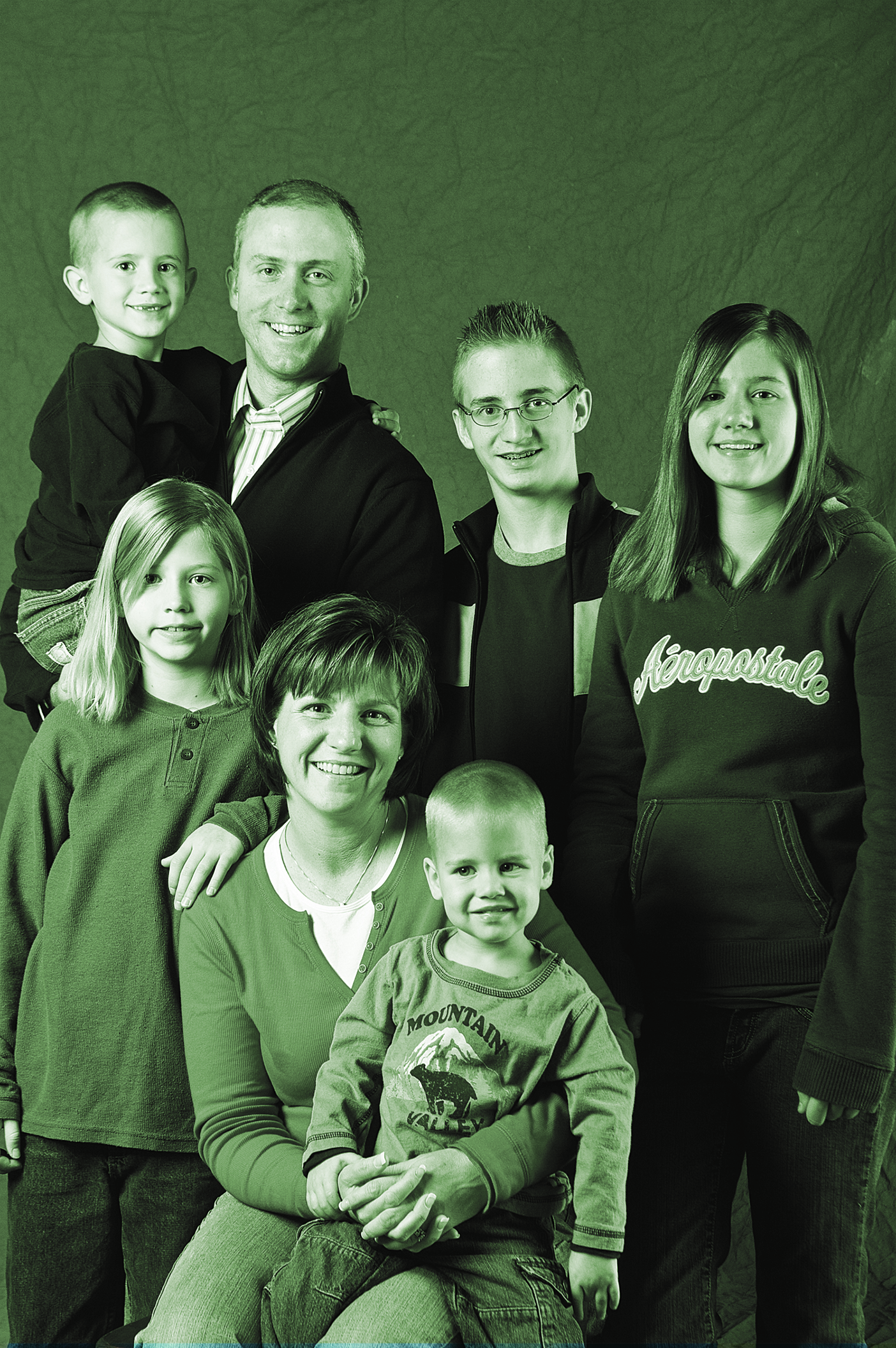 A family with a mom, a dad, and five kids poses for a portrait.