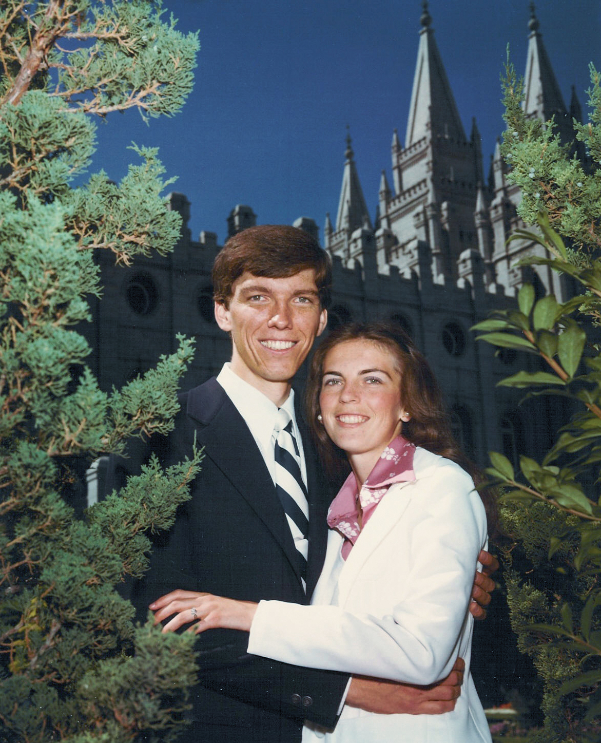Young Christensen posing with his wife in front of the Salt Lake Temple