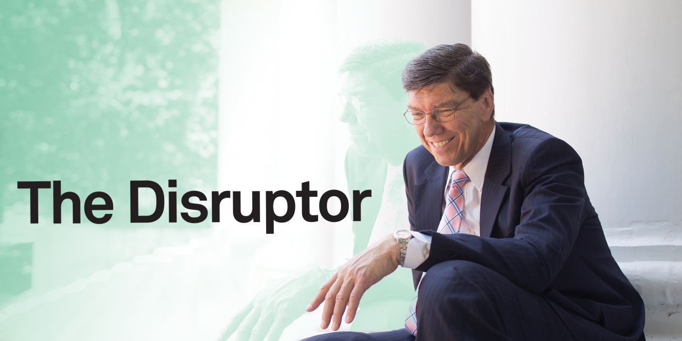 A picture of Clay Christensen sitting on some steps smiling with the title of the story "The Disruptor" next to him