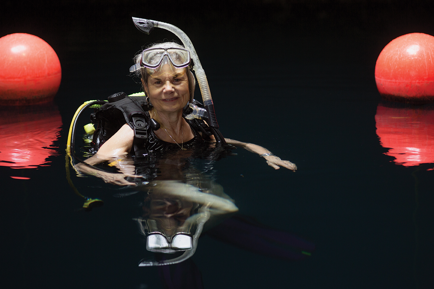 Barbara Culagga floats in water with her scuba gear on