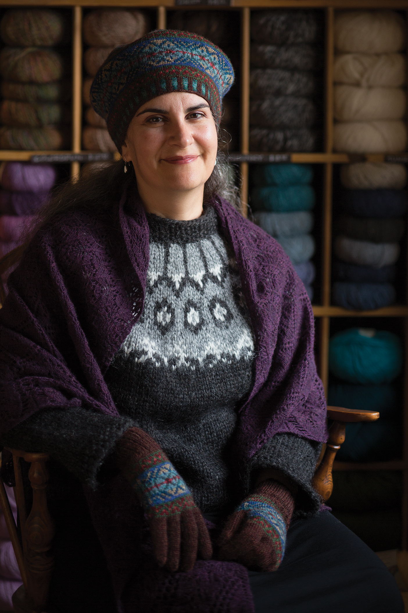 Claudine Bigelow poses in a knitted hat and shawl