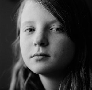 Kylie Turley's daughter looks into the camera. The photo is black and white.