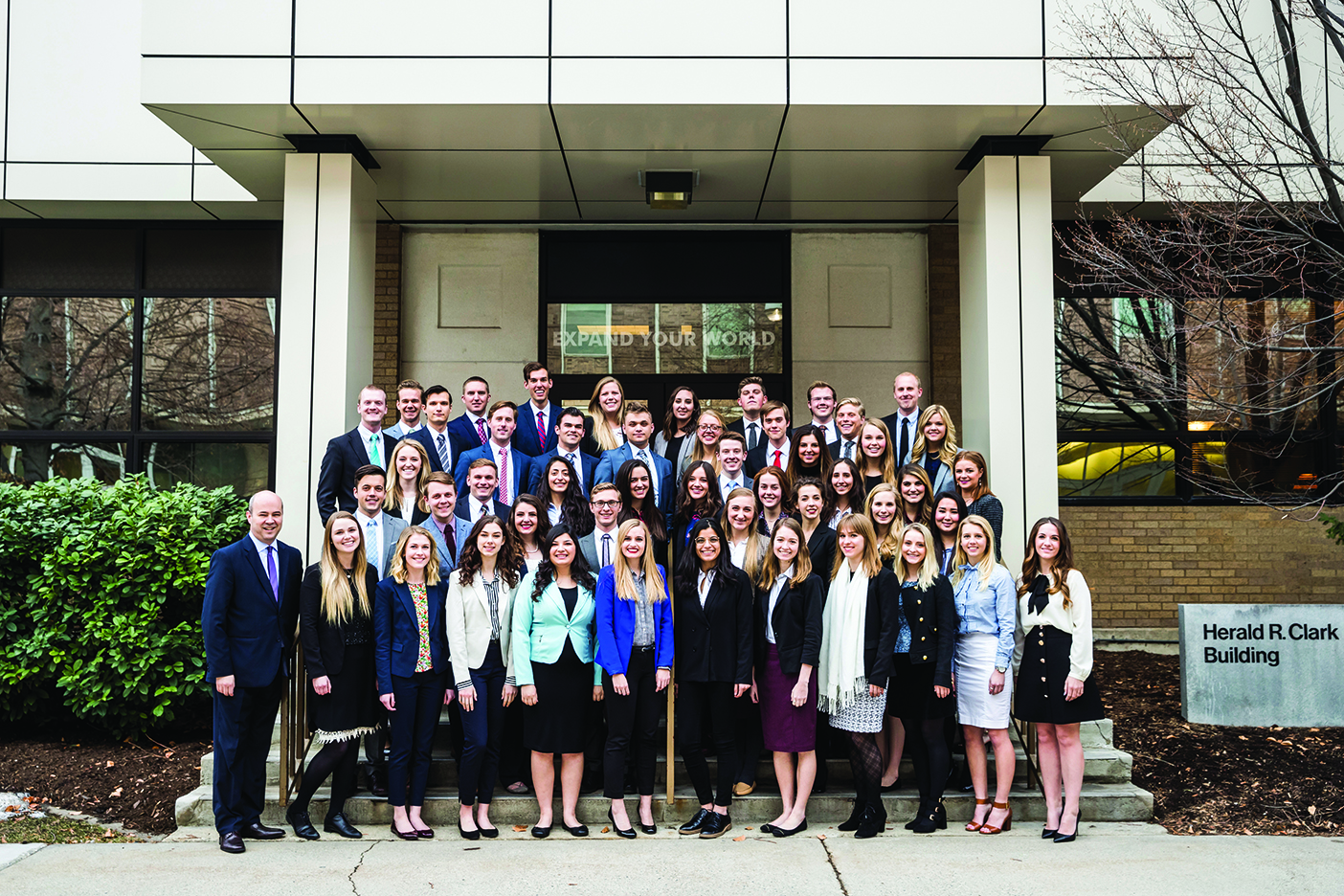 Model United Nations team members, dressed in business attire, pose on the steps of the Kennedy Center.