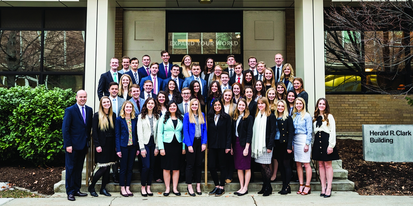 Model United Nations team members, dressed in business attire, pose on the steps of the Kennedy Center.