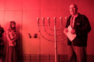 Donald Parry stands in front the menorah, giving a tour of Israelite tabernacle replica.