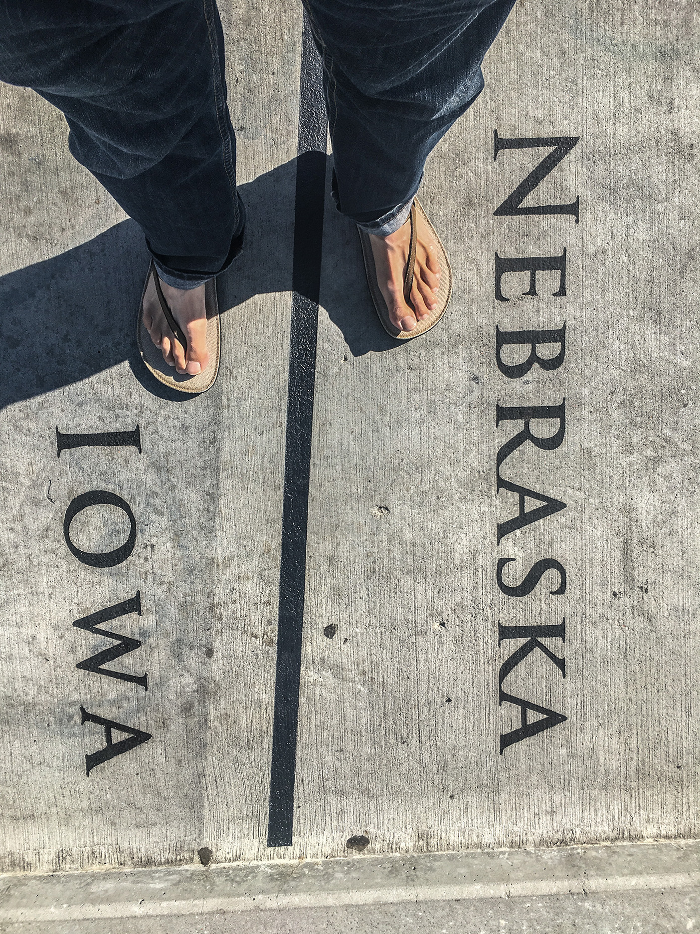 Feet straddling the Nebraska/Iowa border.