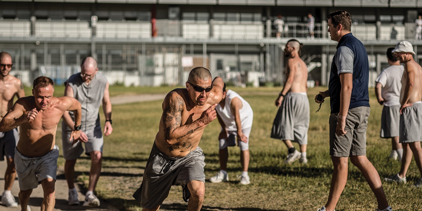 Inmates at the Utah State Prison run on a dirt track in the prison yard.