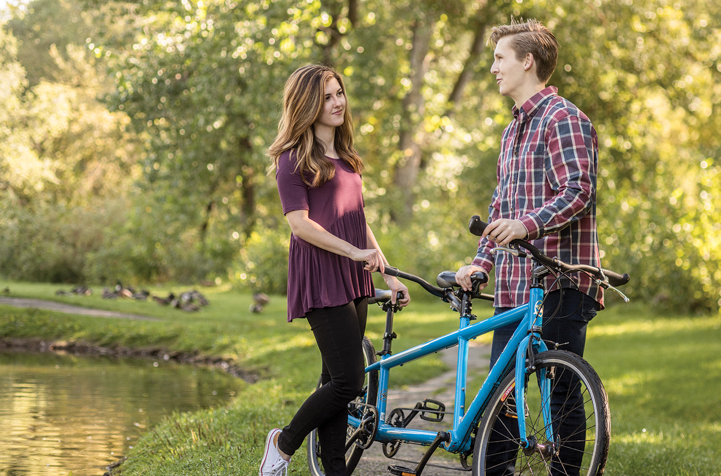 Young couple talking with a bicycle