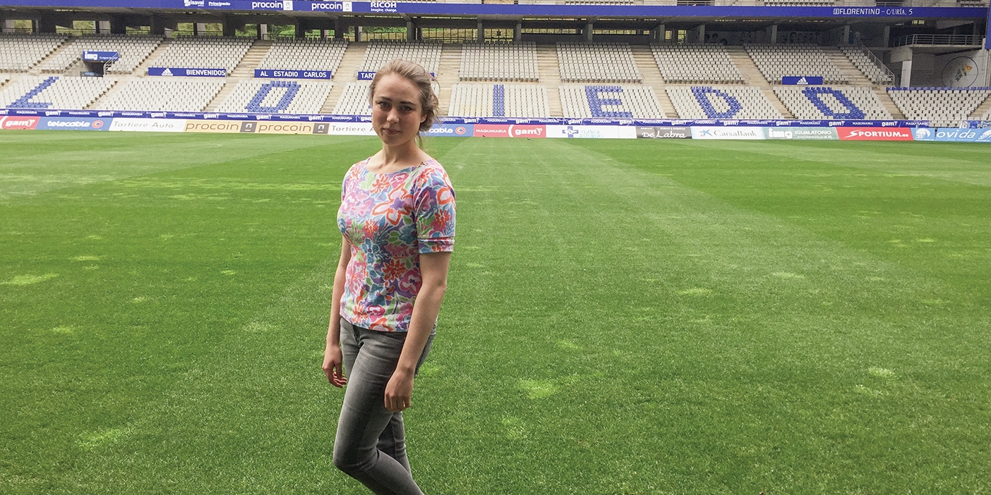 Mallory Stack poses on the field of the Real Oviedo soccer stadium