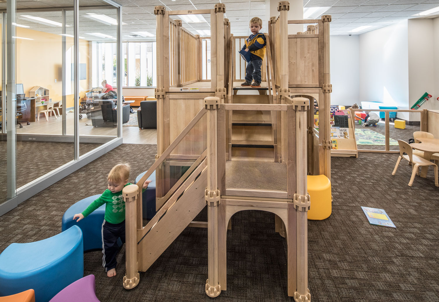 Kids play on the play structure n the new family study room