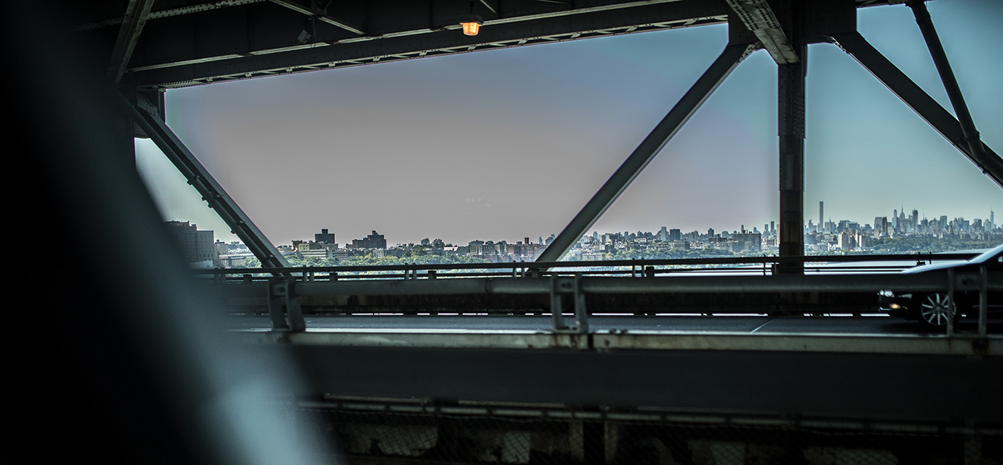 Photo of the New York City skyline from a bridge.