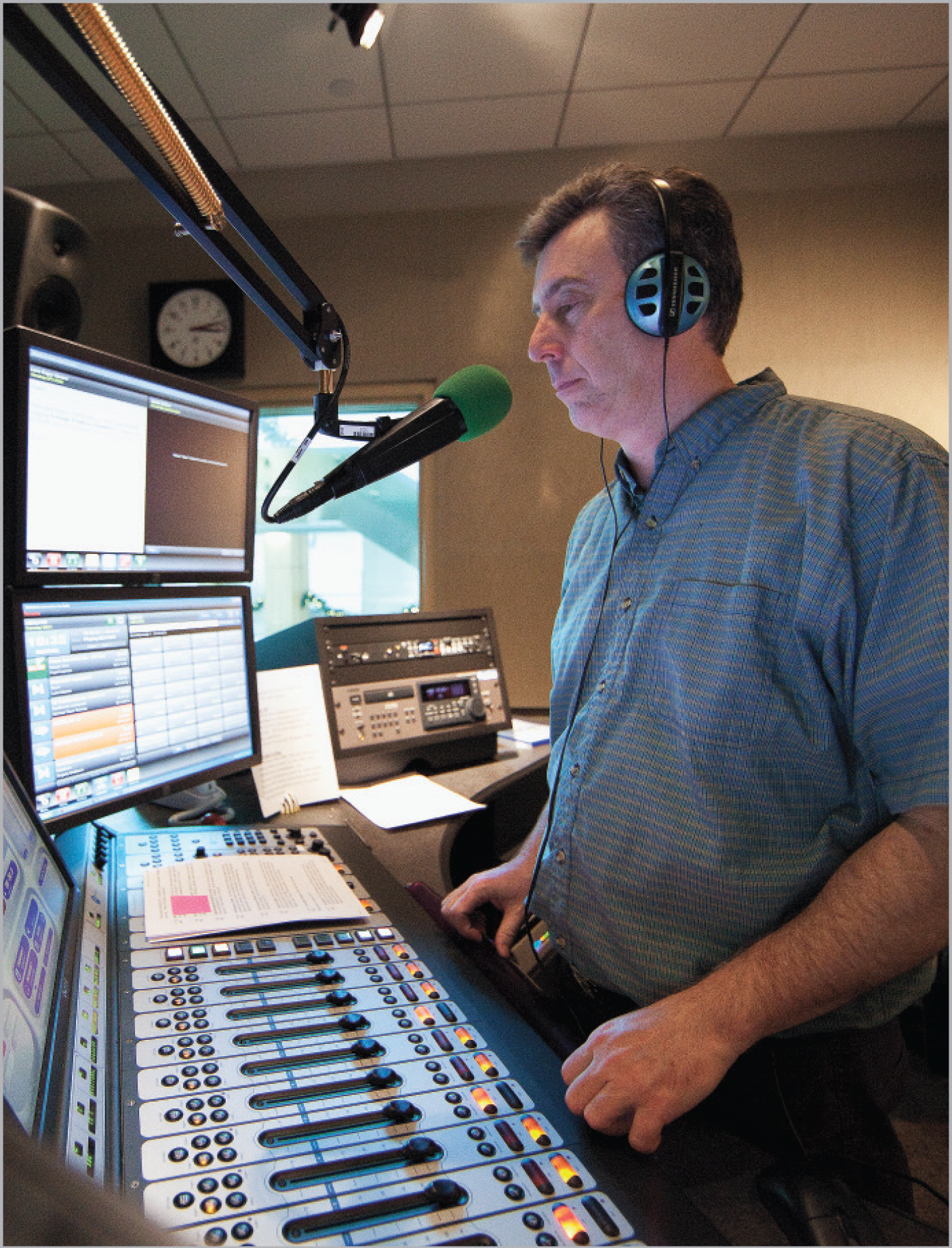 Man standing in a radio control room.