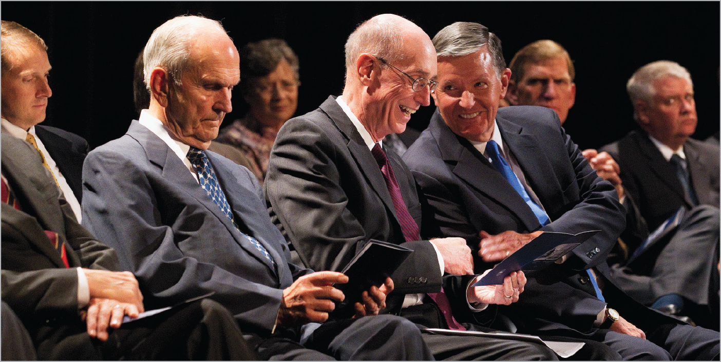 Men sitting in chars at a dedication ceremony.