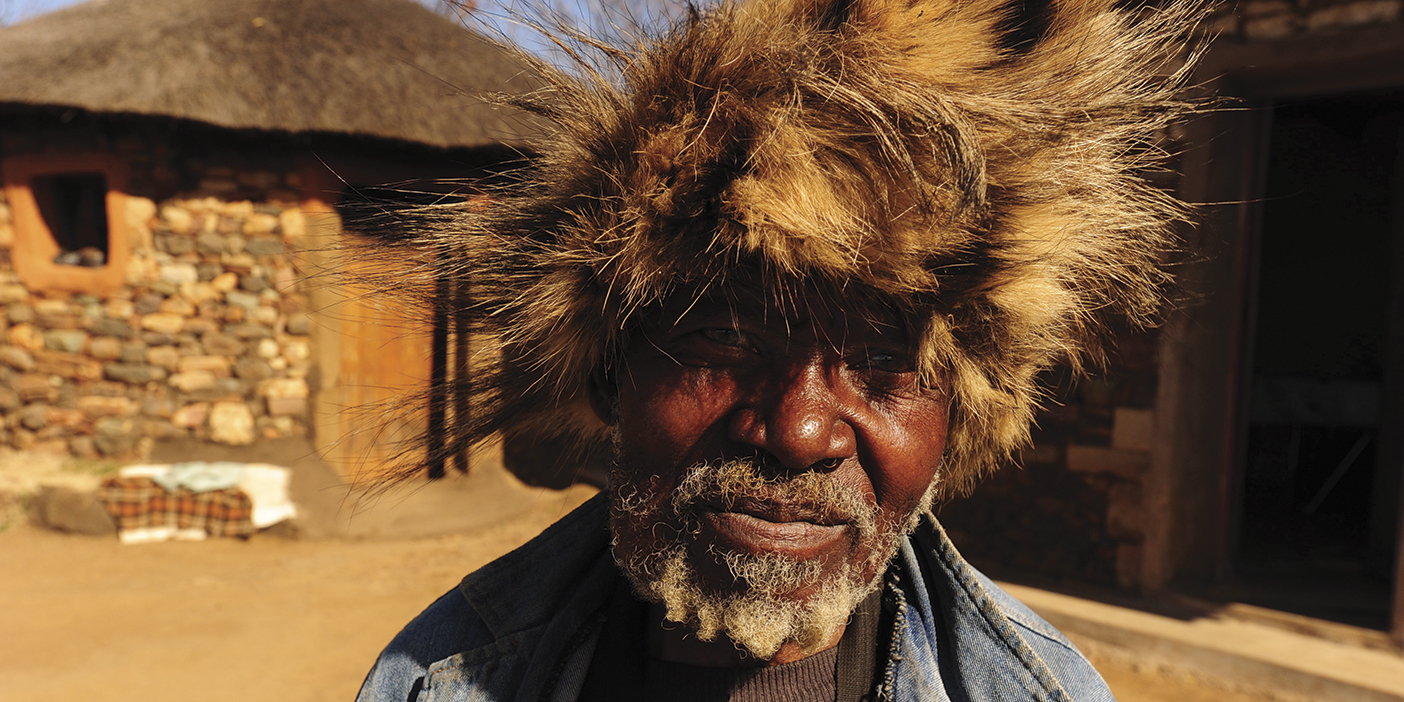 A traditional healer wearing a fur hat.