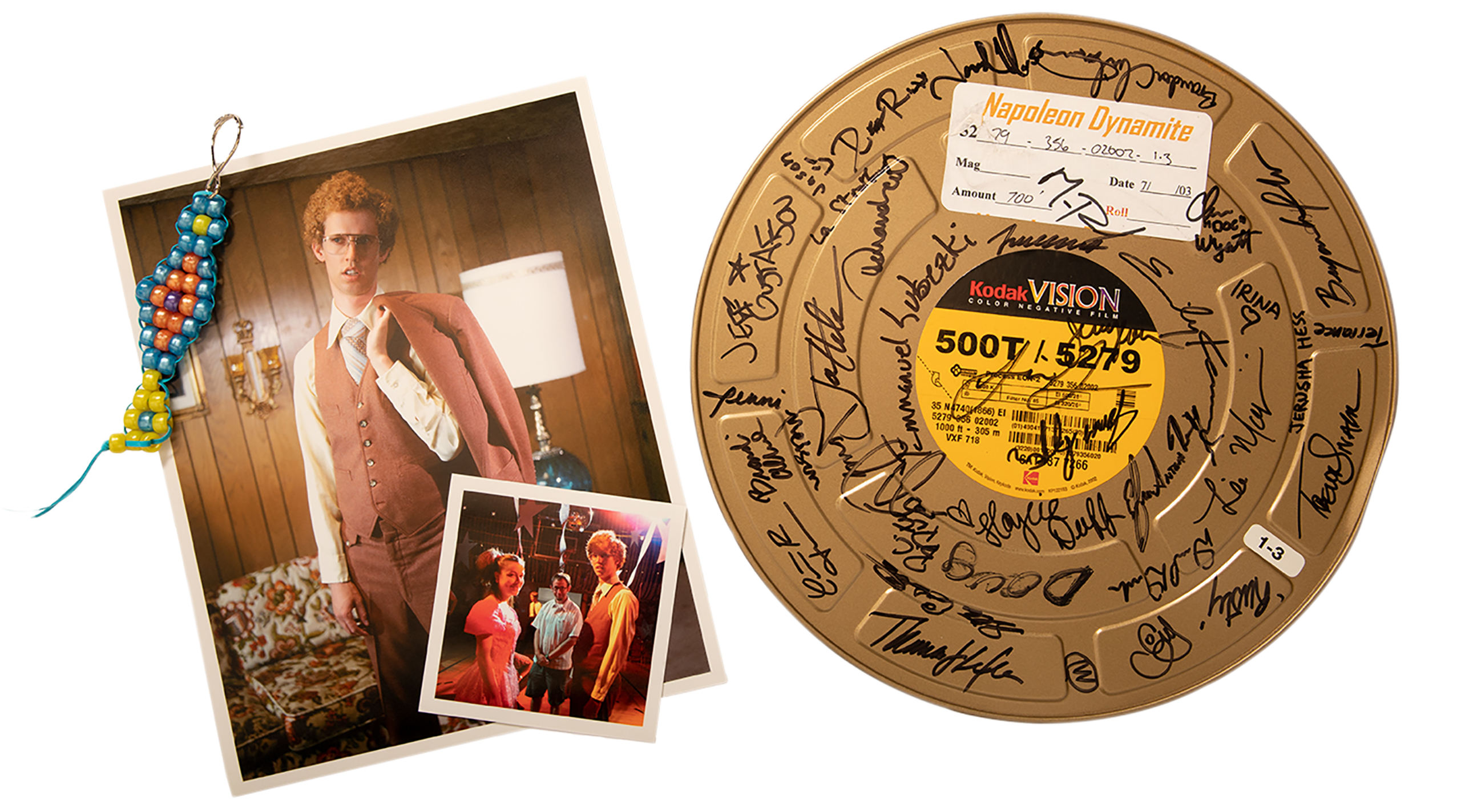 A photo of a boondoggle from the film alongside a photo of Napoleon in his brown suit, a photo of Deb and Napoleon at the school dance, and a film can signed by the team.