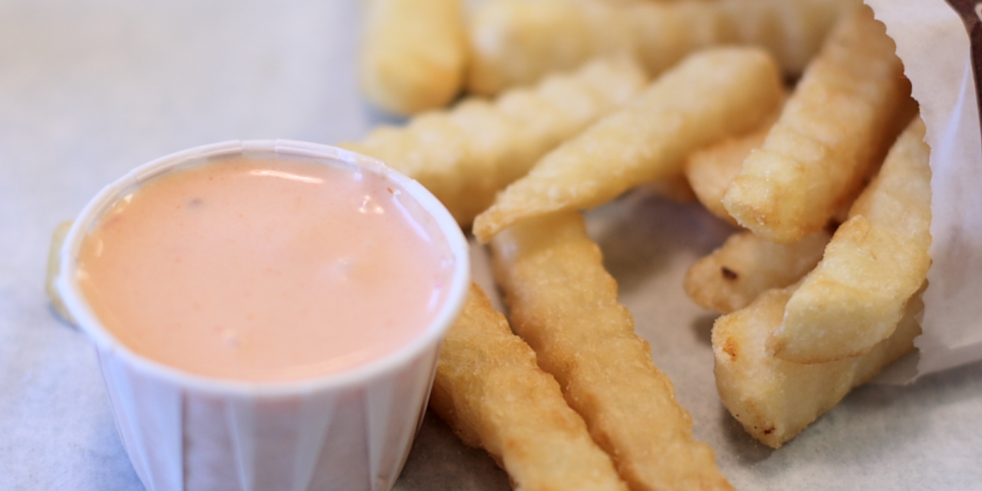 Photo of french fries and a ramekin of fry sauce.
