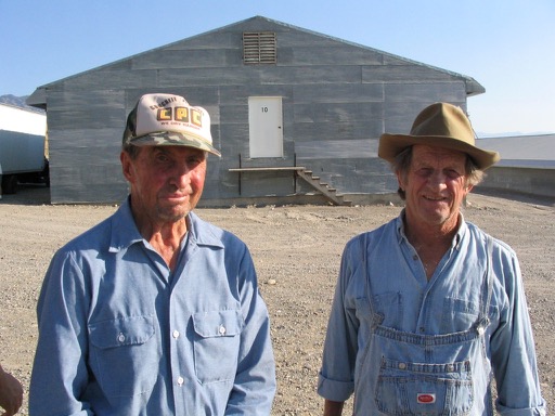 Dale Critchlow and Pat Donahue stand in front of the egg farm in costume.