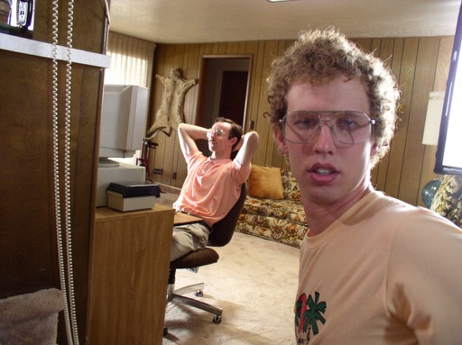 Jon Heder (as Napoleon) takes a selfie with Aaron Ruell (as Kip) in the background.