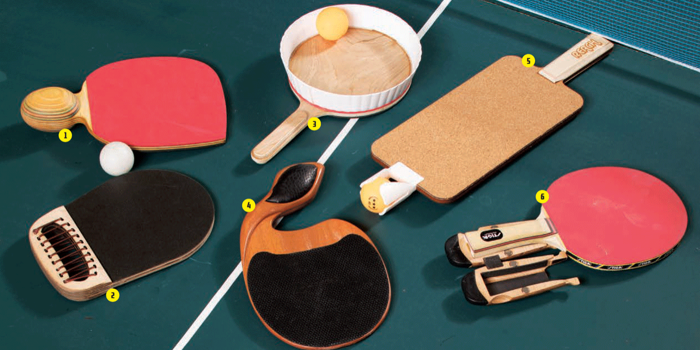 A photograph of six unique ping pong paddles lying on a ping pong table.