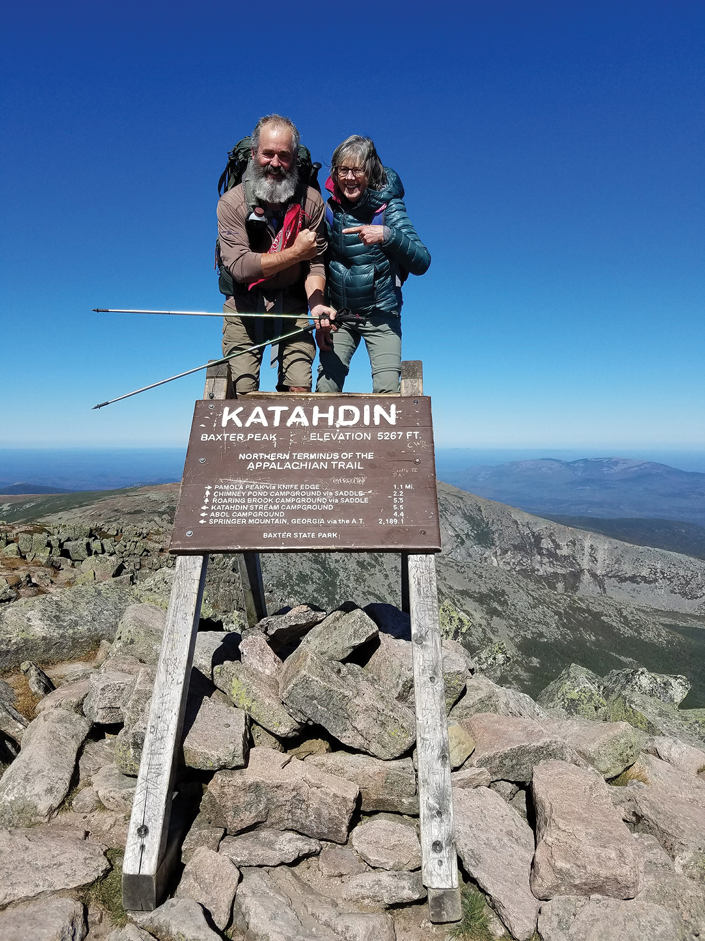 A couple poses on the summit on the Appalachian Trail.