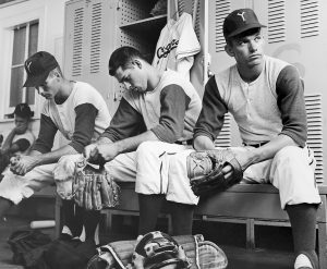 Three BYU baseball players look discouraged after being unable to compete in the College World Series.