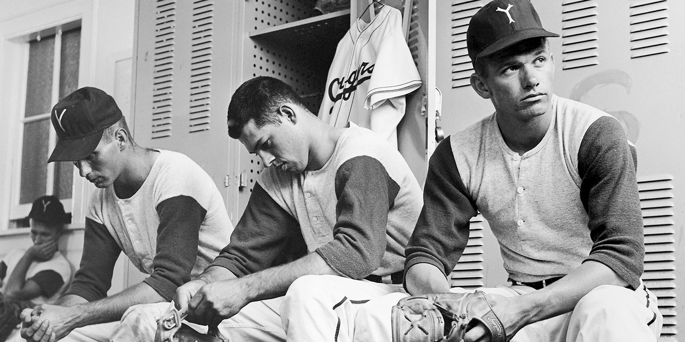Three BYU baseball players look discouraged after being unable to compete in the College World Series.