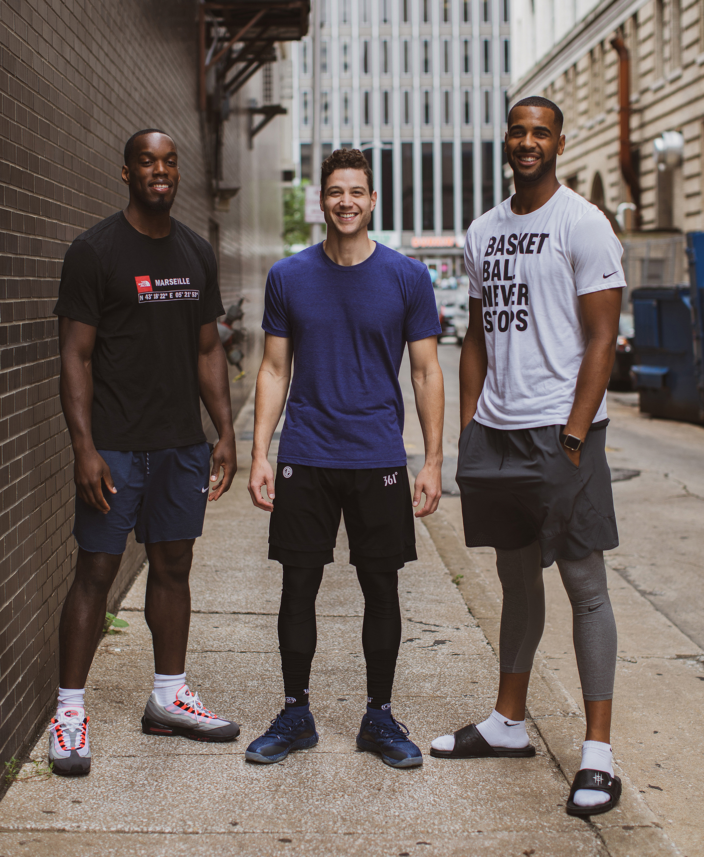 Charles Abouo, Jimmer Fredette, and Brandon Davis pose together.