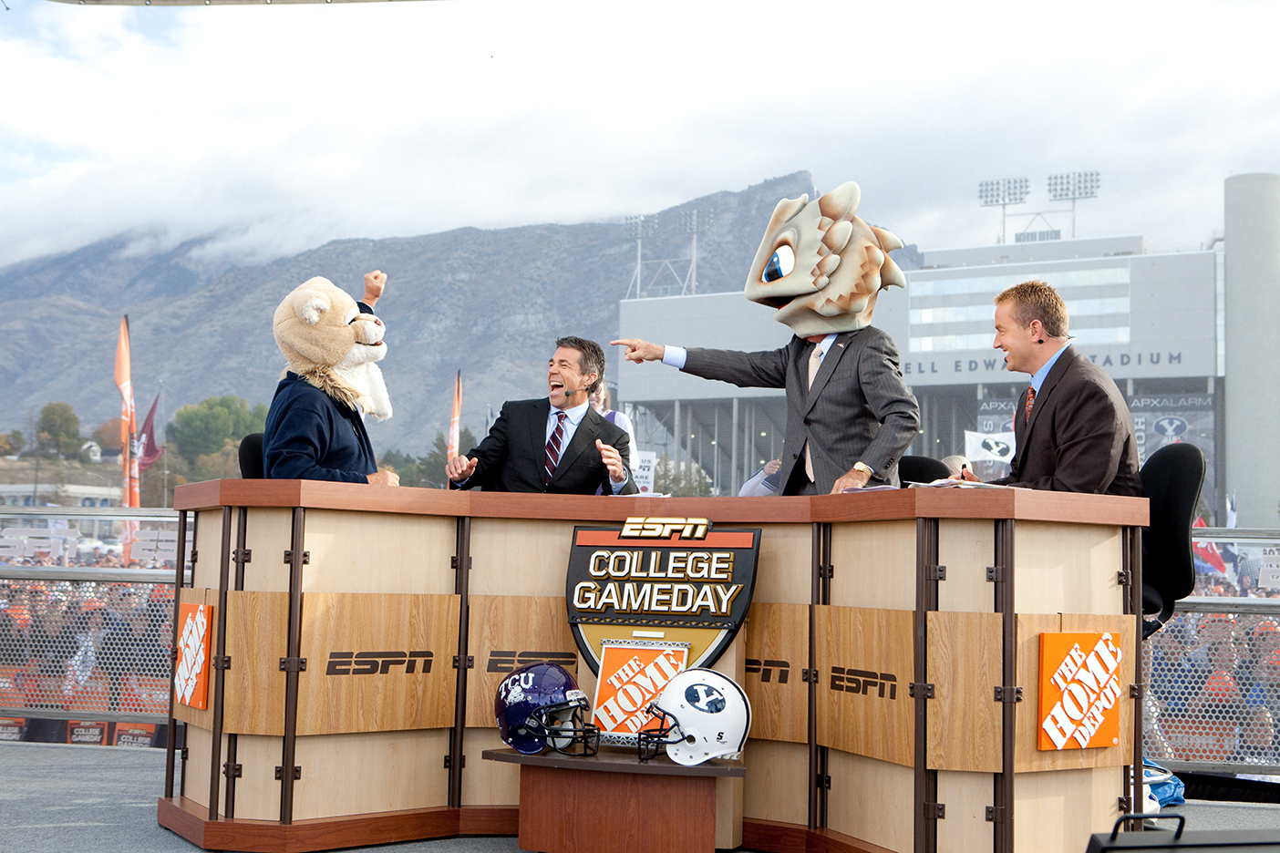 LaVell Edwards wear Cosmo's head on a live broadcast of ESPN College Gameday with Lee Corso who is wearing the TCU SuperFrog head.