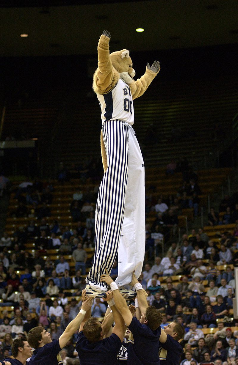 The dunk team raises a stilt-clad Cosmo high in the air.