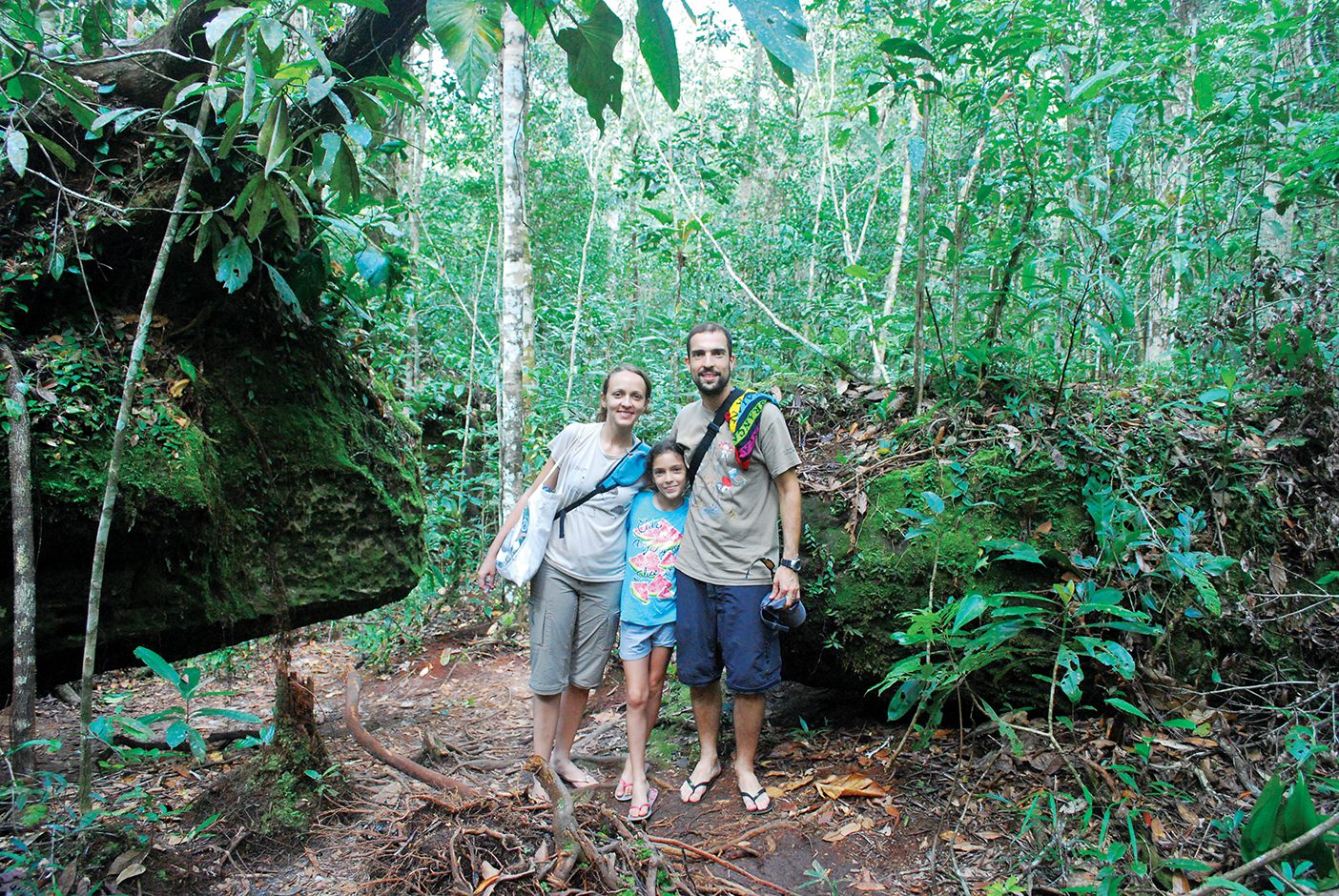 Fernanda Werneck and Rafael Leite, scientists at the National Institute for Amazon Research in Manaus, Brazil, stand in a patch of Amazon forest with their daughter, Iara.