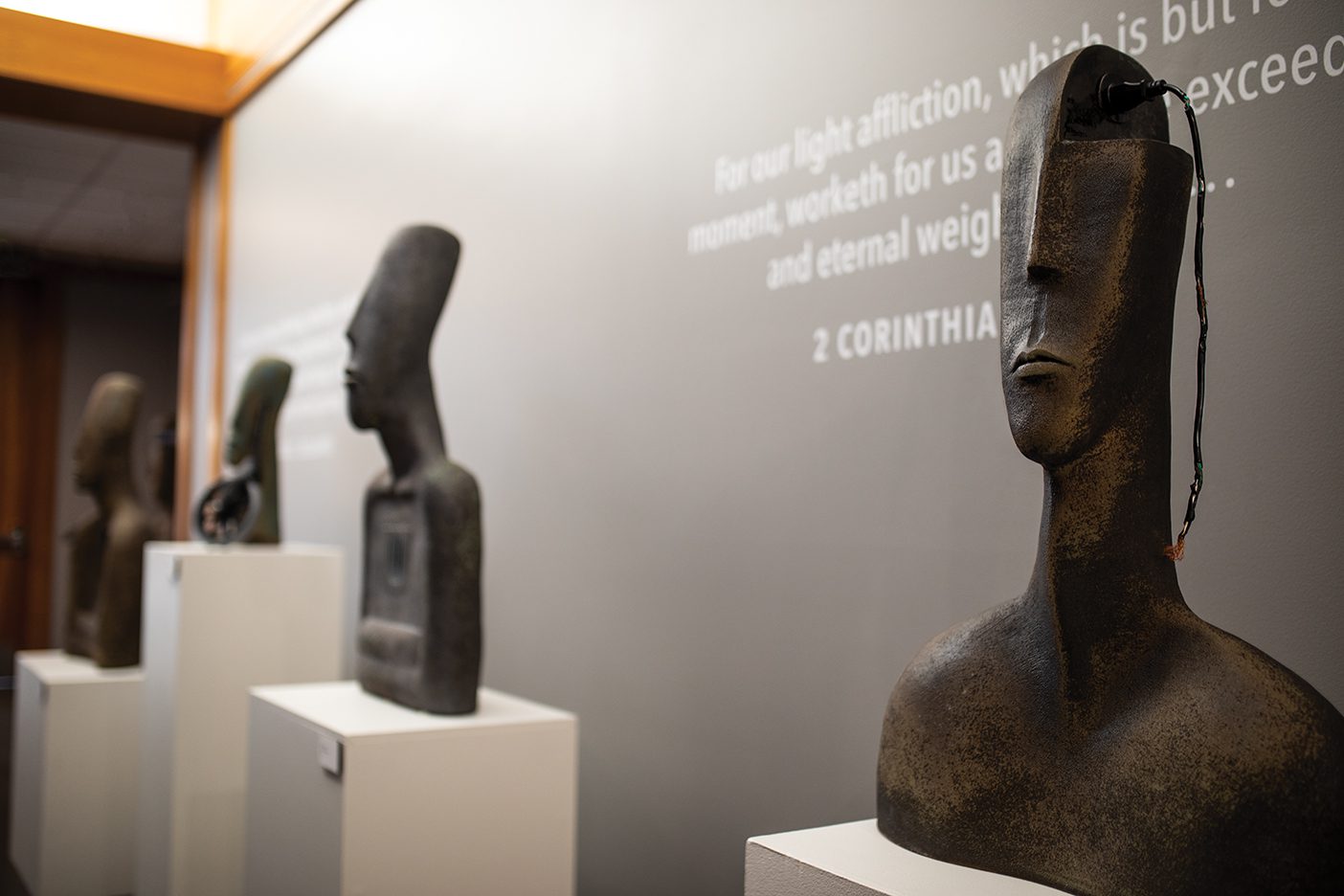 Large ceramic statue heads with damaged electric cords protruding out of them.