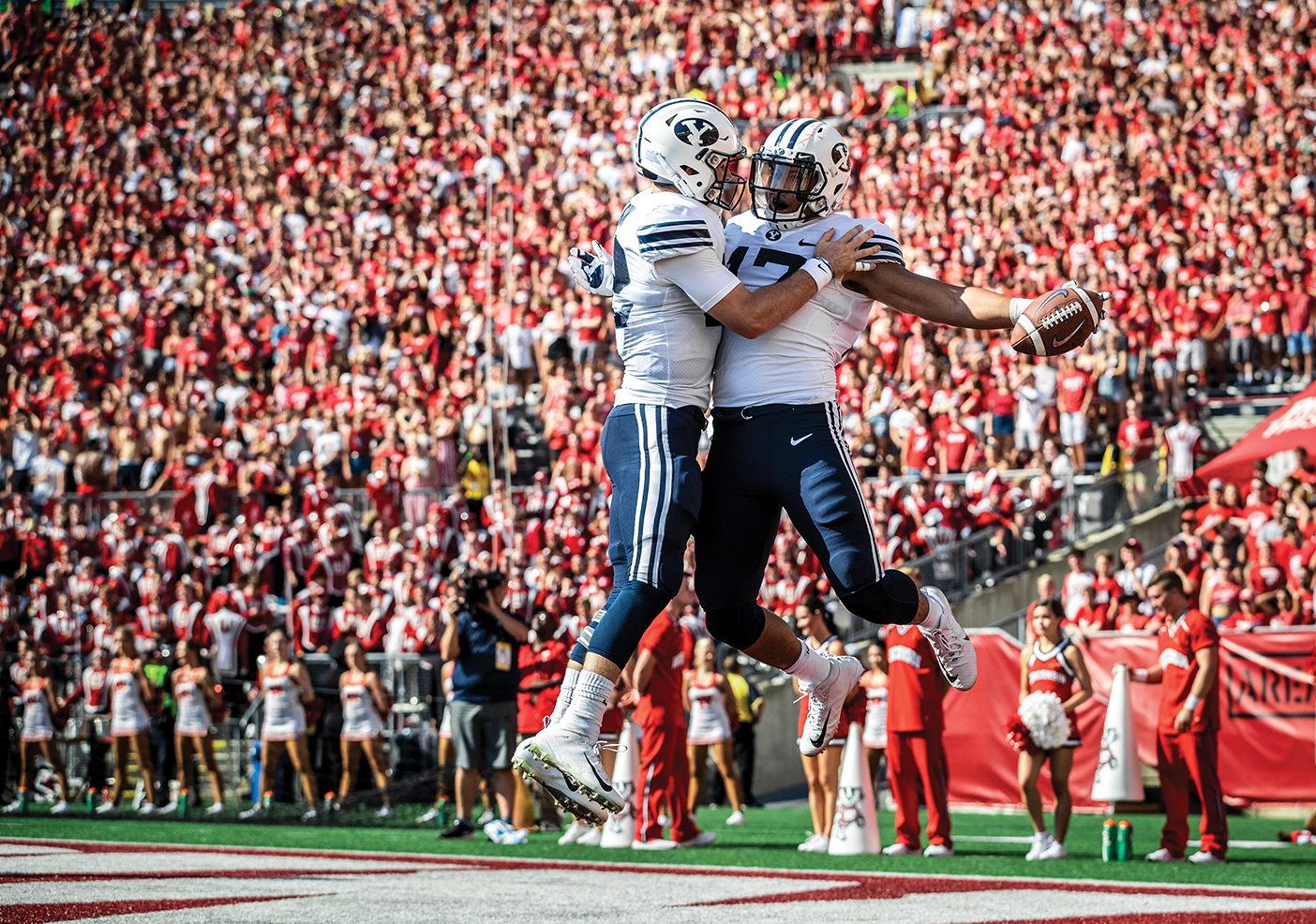 BYU football players Tanner Mangum and Moroni Laulu-Pututau celebrate following a touchdown at at football game at Wisconsin in September 2018.