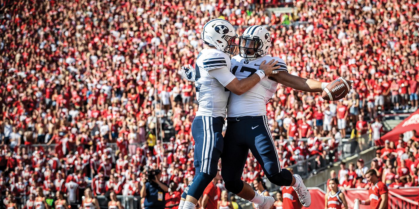 BYU football players Tanner Mangum and Moroni Laulu-Pututau celebrate a touchdown at Wisconsin in September 2018.