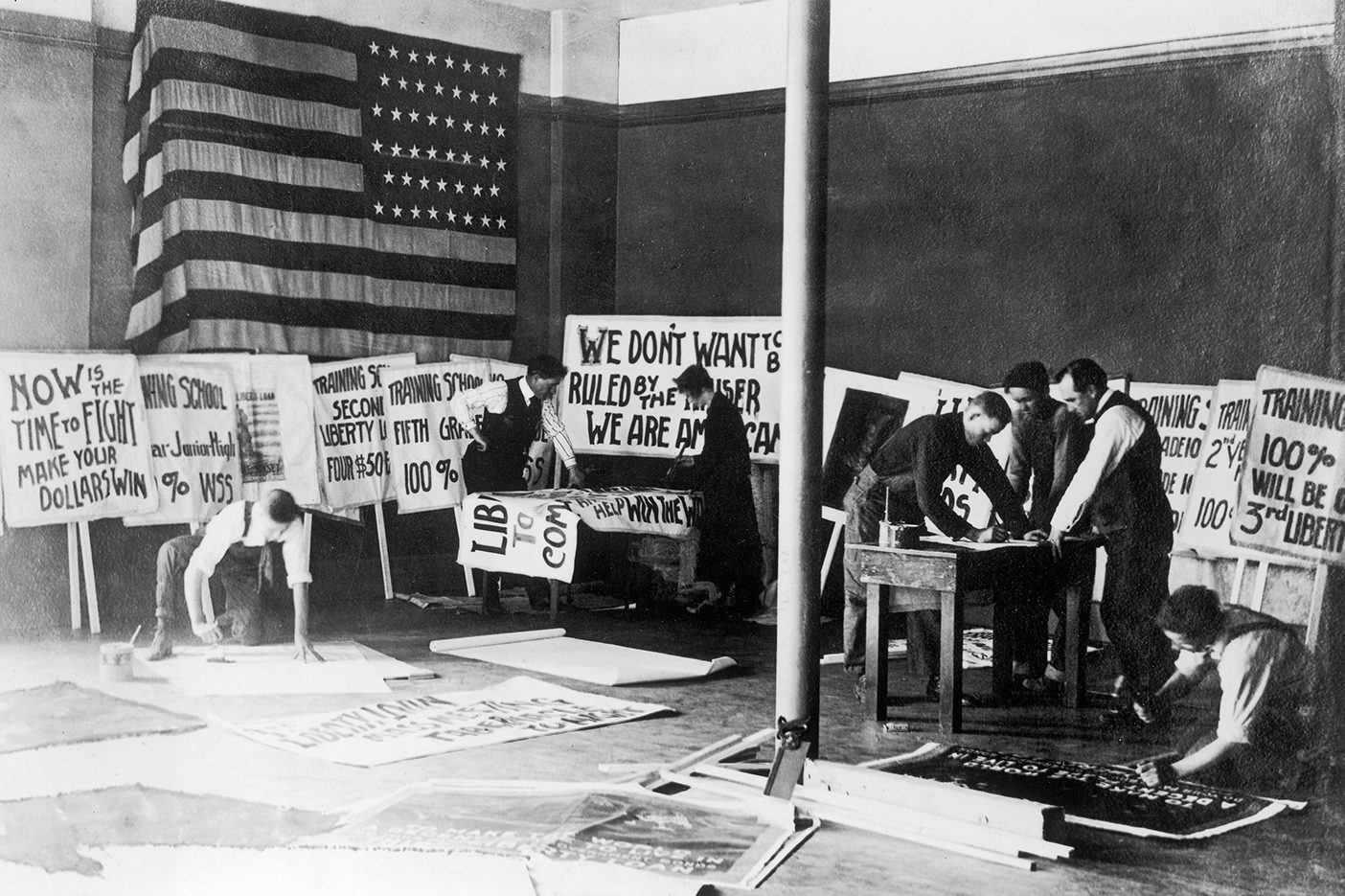 Students at BYU during World War I make posters to raise funds for the war.
