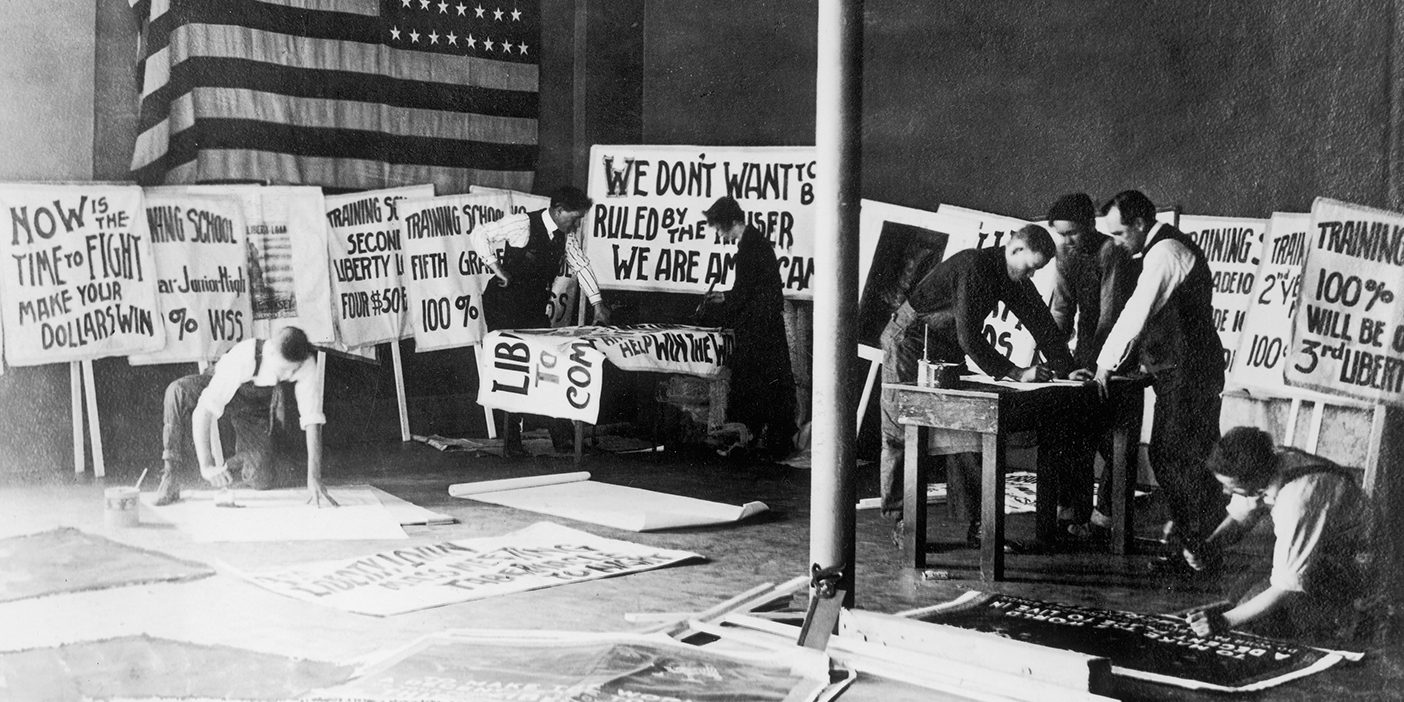 Students at BYU during World War I make posters to raise funds for the war.