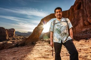 Stacy Taniguchi stands before Corona Arch.