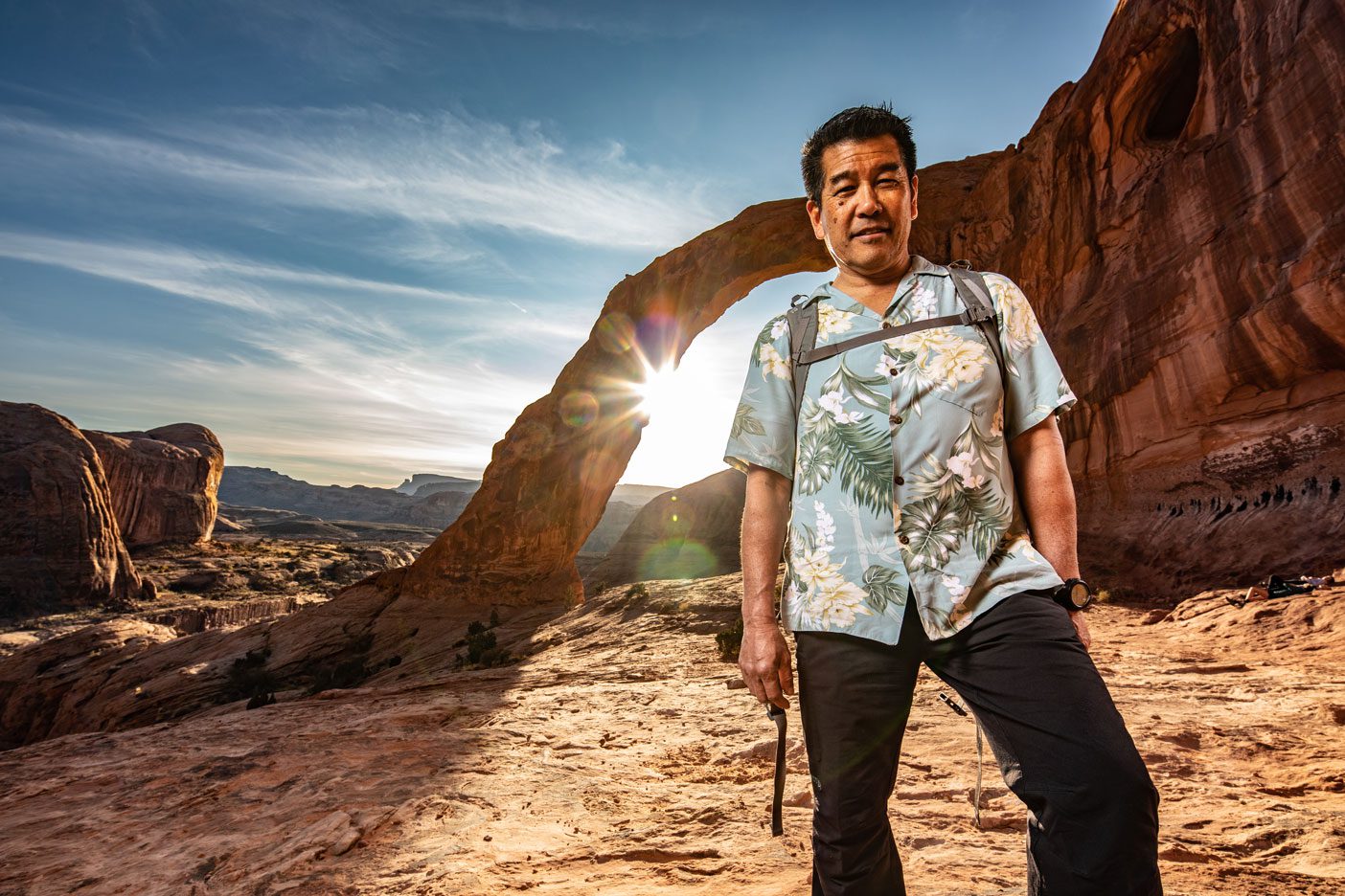 Stacy Taniguchi stands before Corona Arch.